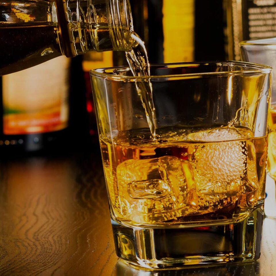 A man pouring chilled whiskey into the glass