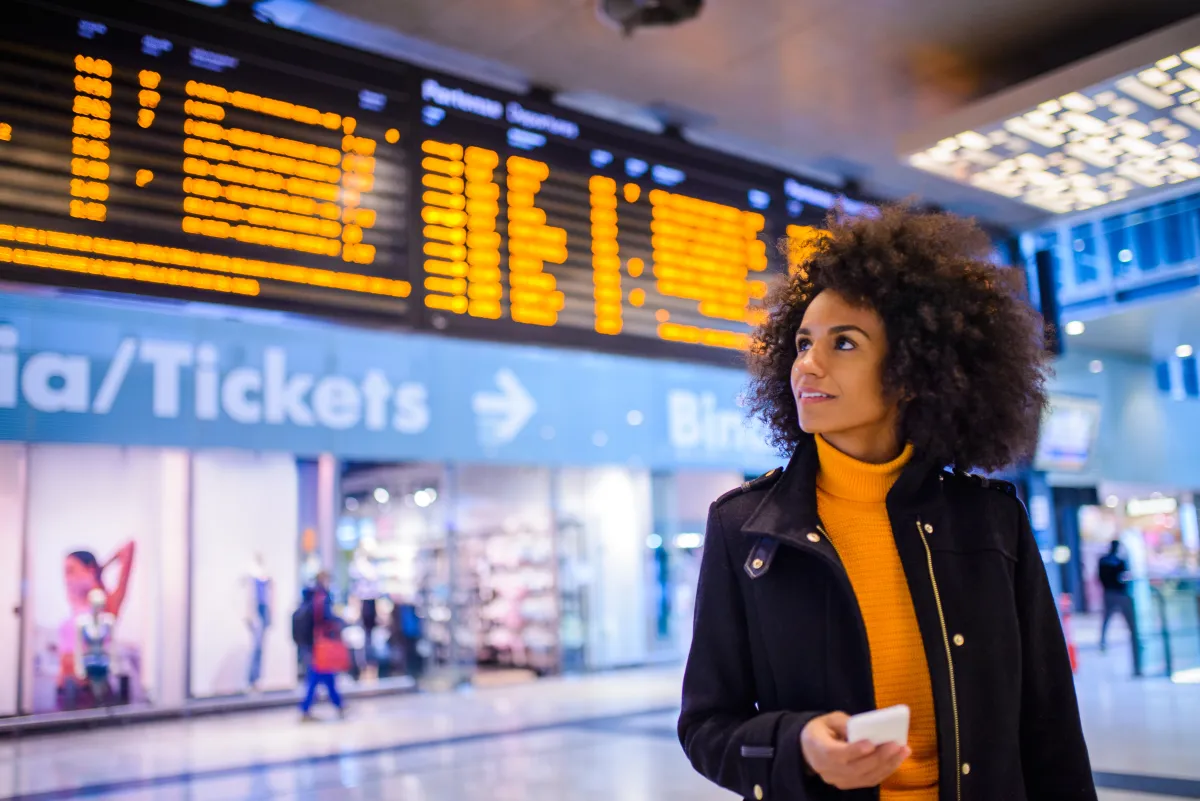 A picture of the black woman standing at the airport